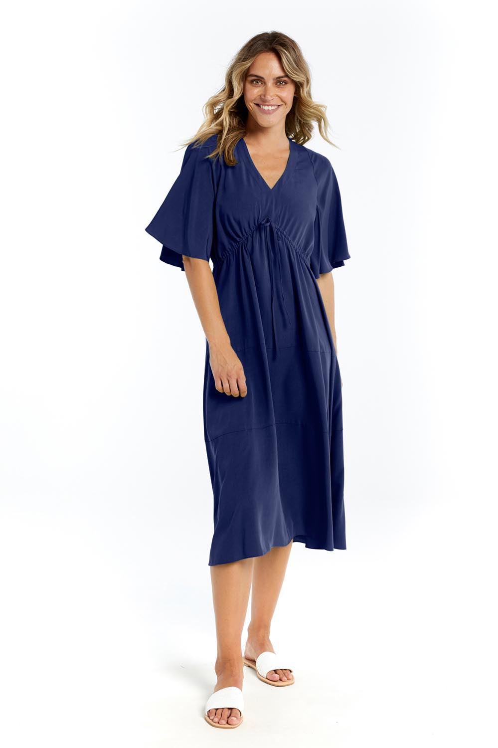 A model wearing the Cora Cotton Dress in colour Frenchblue (Blue), from the front, showing the whole outfit