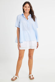 Model Madeline wearing size 10 of the Sydney Smock Shirt in colour Blueseer (Blue), from the front, showing the whole outfit