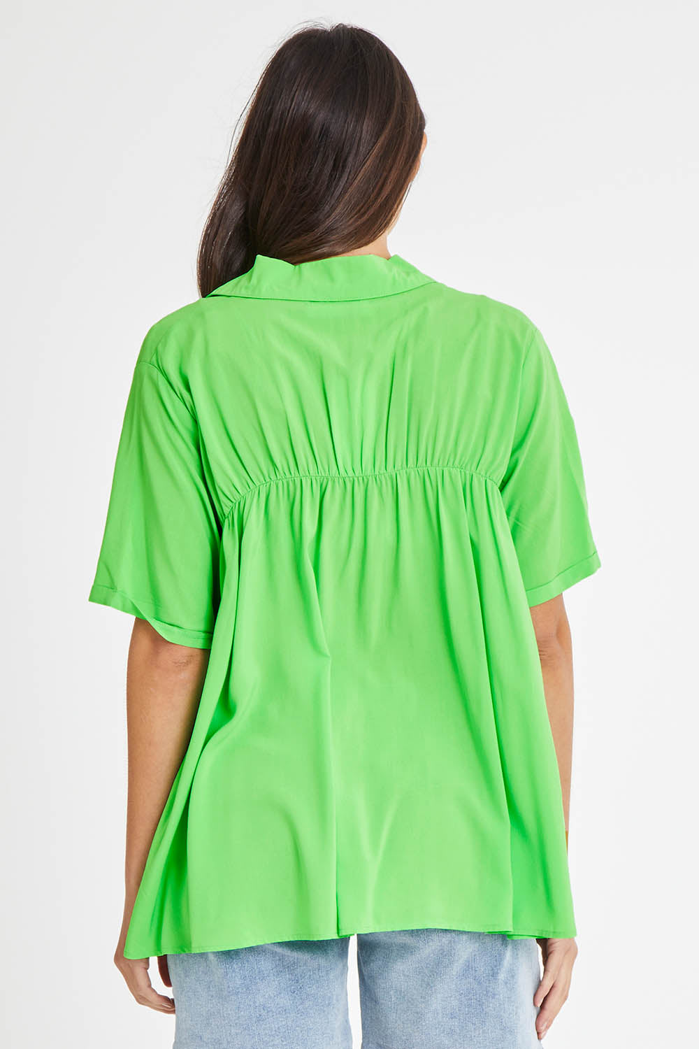 Model Madeline wearing size 10 of the Sydney Smock Shirt in colour Green (Green), from the back