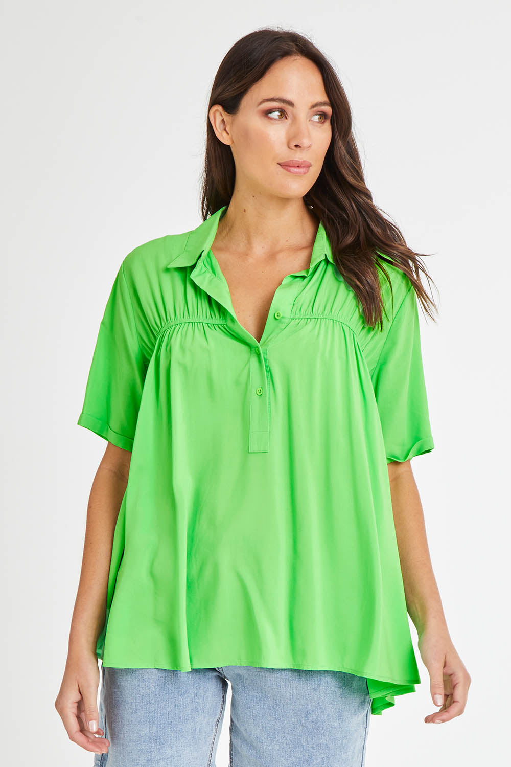 Model Madeline wearing size 10 of the Sydney Smock Shirt in colour Green (Green), from the front, cropped image