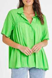 Model Madeline wearing size 10 of the Sydney Smock Shirt in colour Green (Green), from the front, cropped image