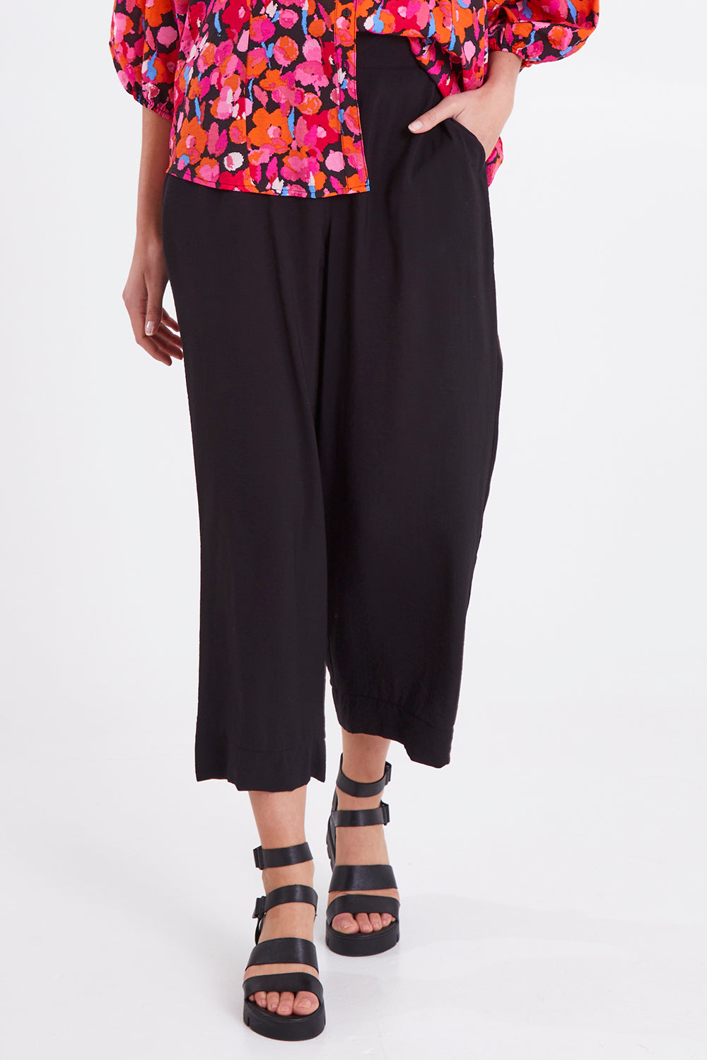 Model Madeline wearing size 10 of the Sarah Pant in colour Black (Black), from the front, cropped image