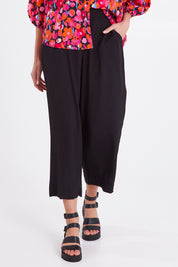 Model Madeline wearing size 10 of the Sarah Pant in colour Black (Black), from the front, cropped image