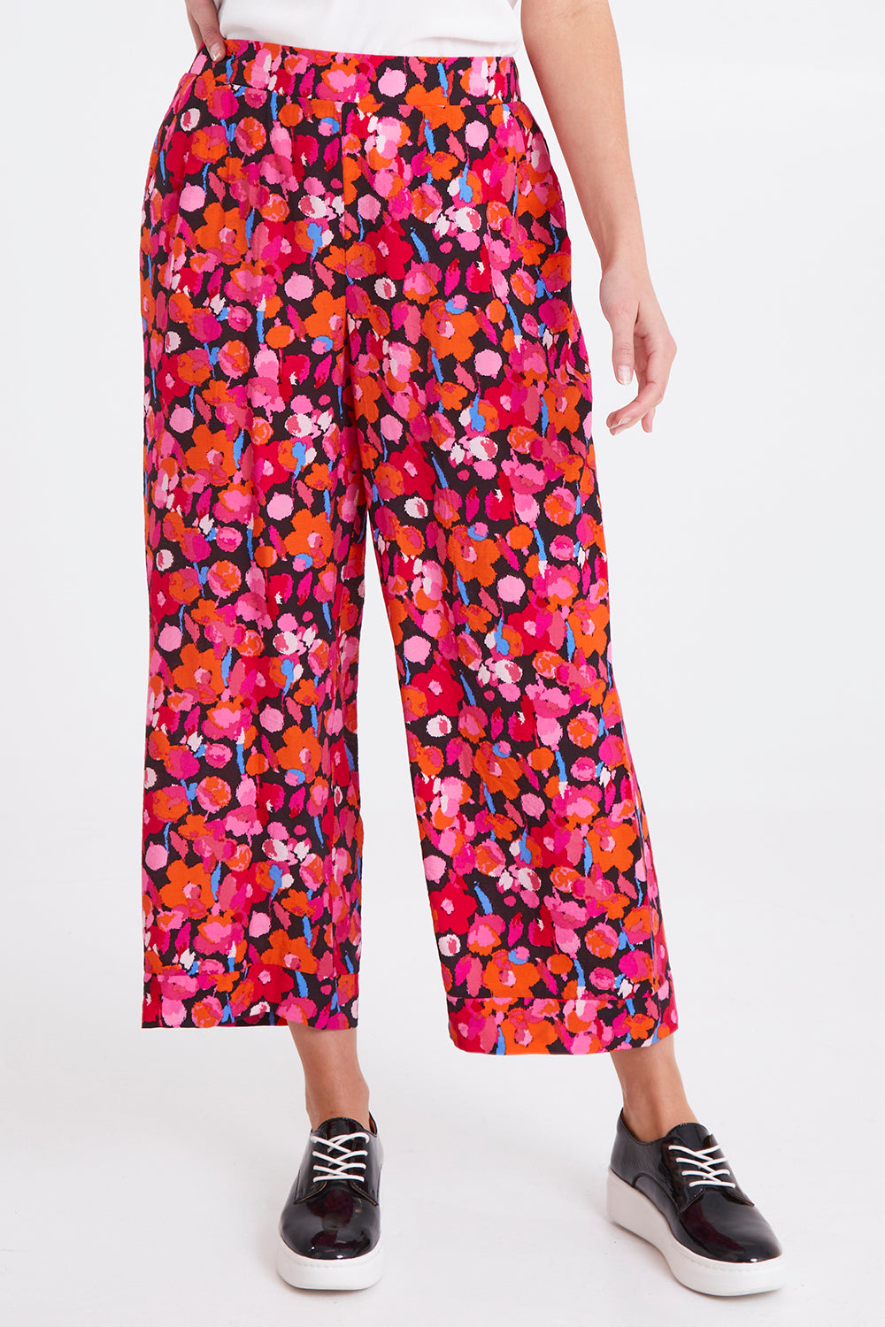 Model Madeline wearing size 10 of the Sarah Pant in colour Brushflora (Pink), from the front, cropped image
