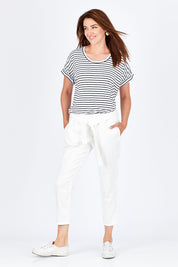 Model Rebecca wearing size 10 of the Jude Stretch Denim Pant in colour White (White), from the front, showing the whole outfit