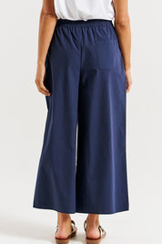 A model wearing the Lulu Cotton Pant in colour Navy (Blue), from the back