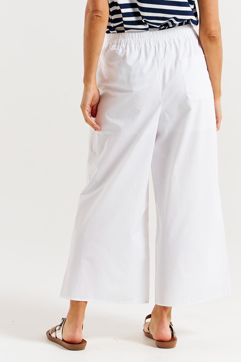 A model wearing the Lulu Cotton Pant in colour White (White), from the back