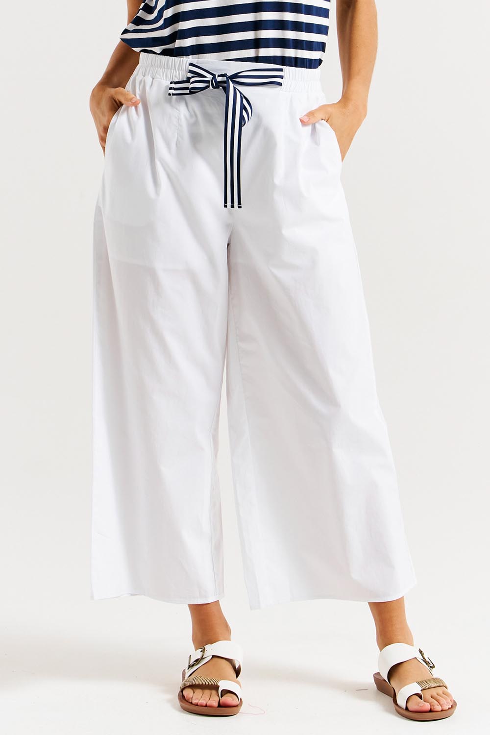 A model wearing the Lulu Cotton Pant in colour White (White), from the front, cropped image