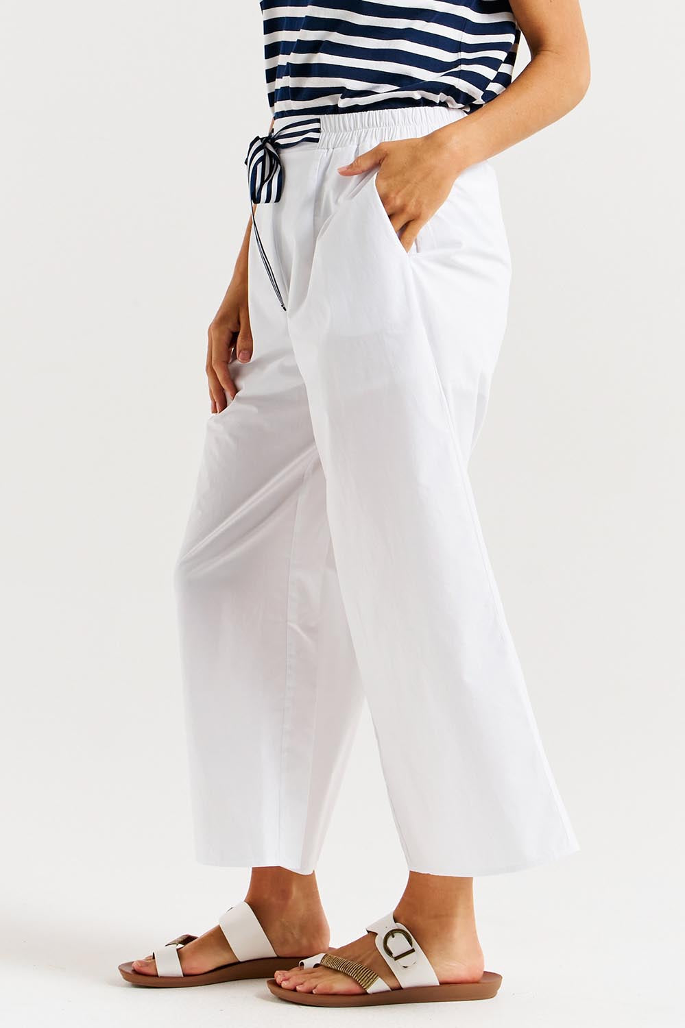 A model wearing the Lulu Cotton Pant in colour White (White), from the front, cropped image