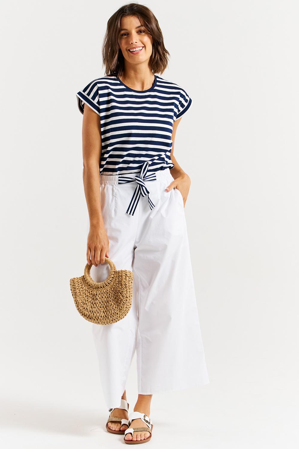 A model wearing the Lulu Cotton Pant in colour White (White), from the front, showing the whole outfit