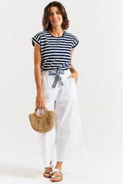A model wearing the Lulu Cotton Pant in colour White (White), from the front, showing the whole outfit