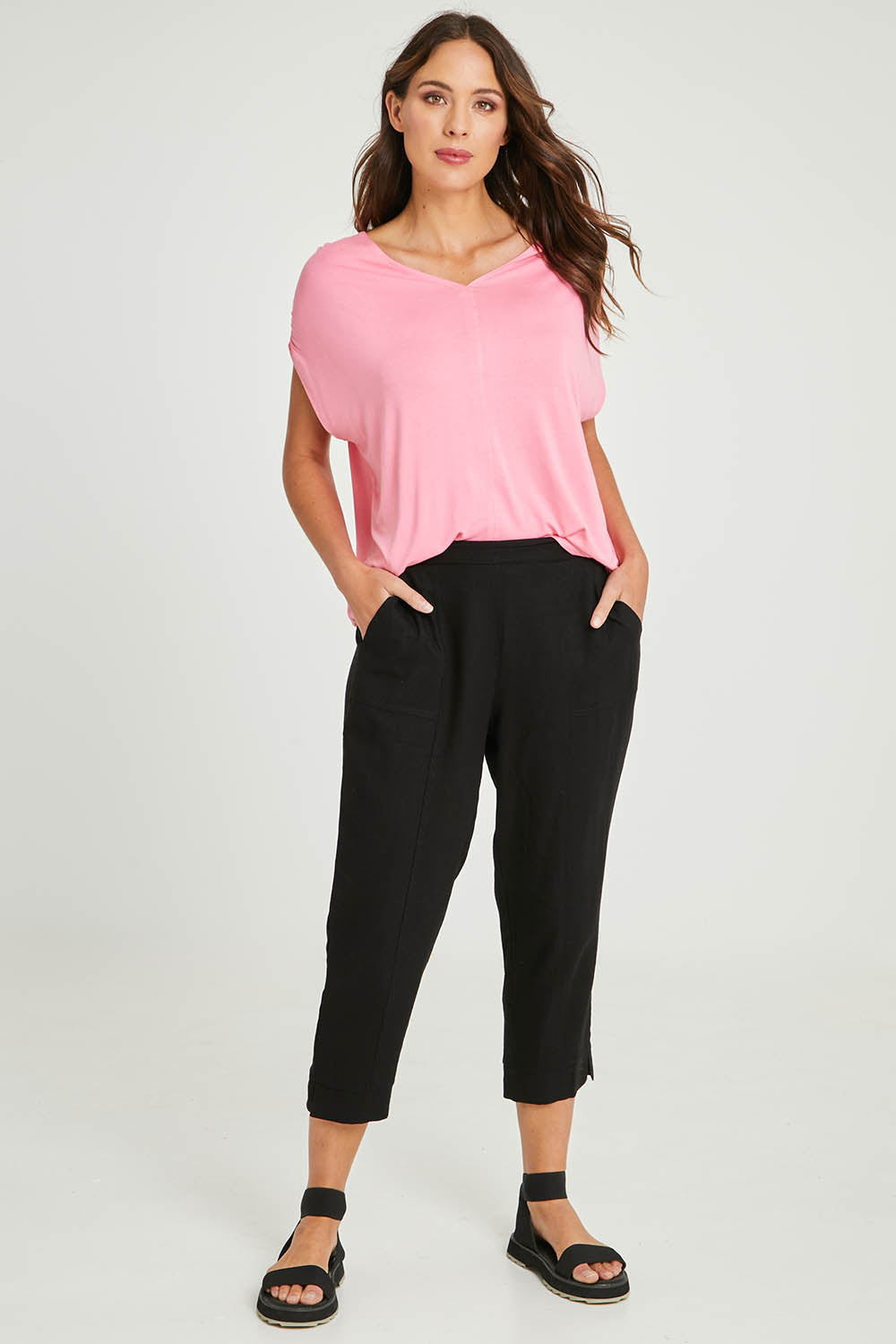 Model Madeline wearing size 10 of the Positano Linen Pant in colour Black (Black), from the front, showing the whole outfit