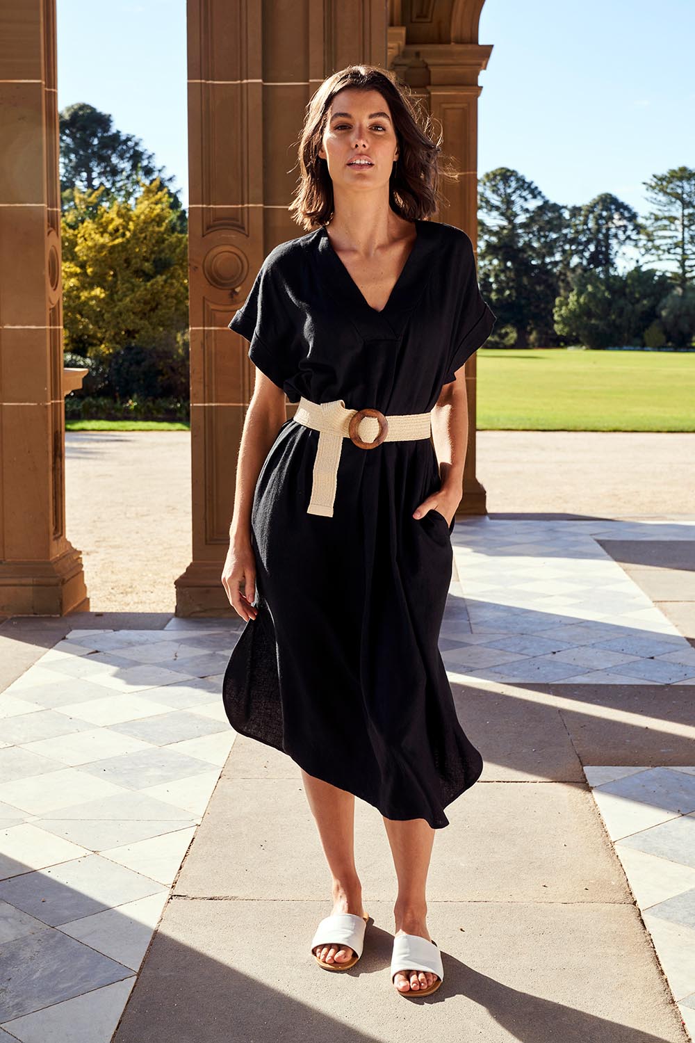 A model wearing the Roma Linen Dress in colour Black (Black), from the front, showing the whole outfit