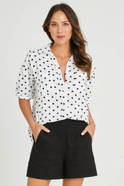 Model Madeline wearing size 10 of the Naples Linen Short in colour Black (Black), from the front, cropped image