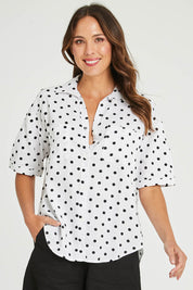 Model Madeline wearing size 10 of the Catania Linen Shirt in colour Polkadot (White), from the front, cropped image