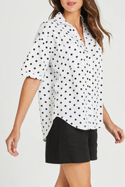 Model Madeline wearing size 10 of the Catania Linen Shirt in colour Polkadot (White), from the front, cropped image