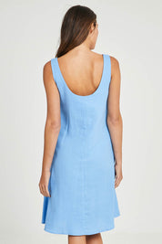 Model Madeline wearing size 10 of the Sicily Linen Dress in colour Cornflower (Blue), from the back