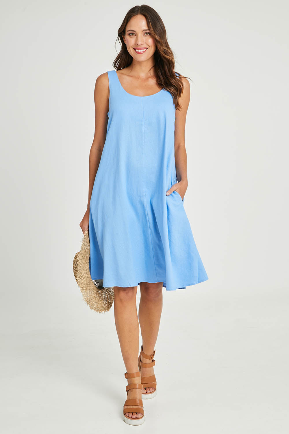Model Madeline wearing size 10 of the Sicily Linen Dress in colour Cornflower (Blue), from the front, showing the whole outfit