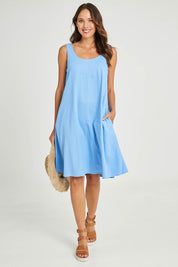 Model Madeline wearing size 10 of the Sicily Linen Dress in colour Cornflower (Blue), from the front, showing the whole outfit