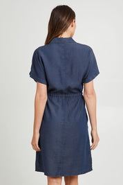 Model Madeline wearing size 10 of the Debra Lyocell Denim Shirt Dress in colour Darkdenim (Blue), from the back