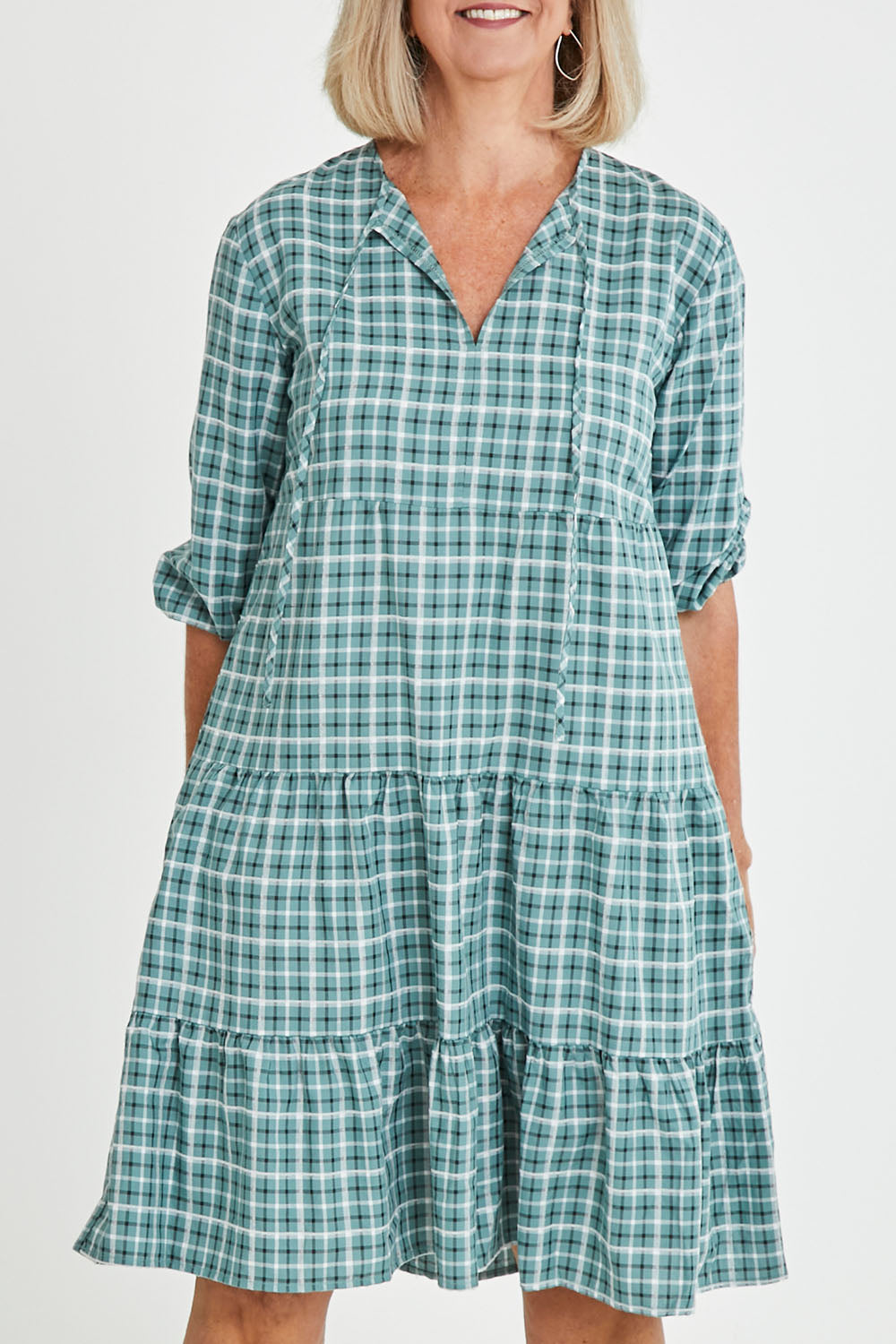 Model Sandy wearing size 10 of the Odette Dress in colour Greenging (Green), from the front, cropped image