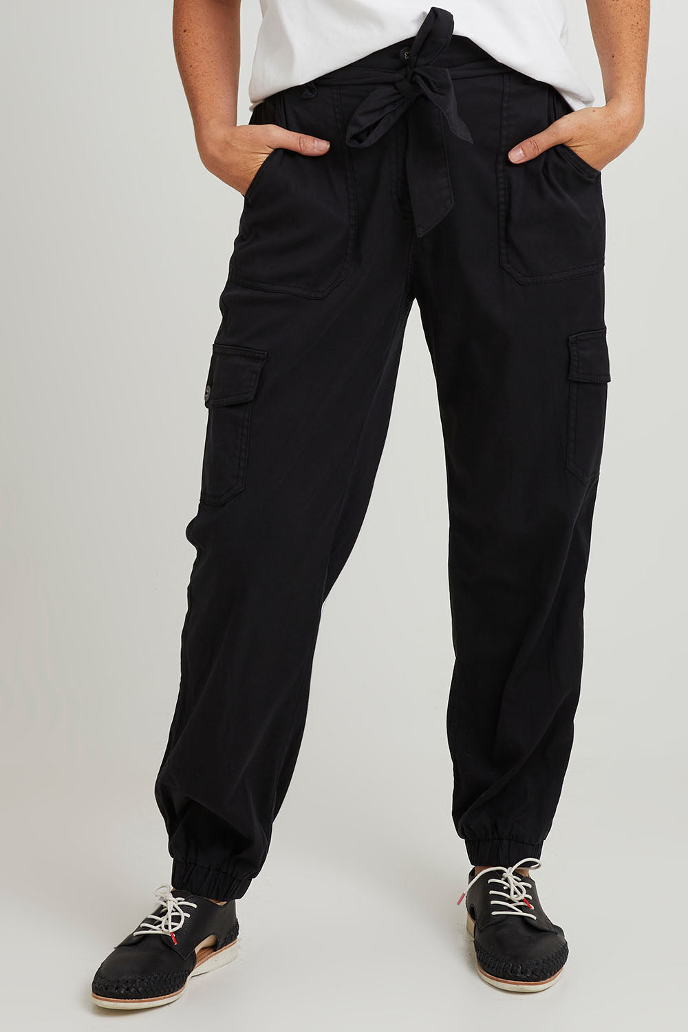 Model Katie wearing size 10 of the Canterbury Lyocell Cargo Pants in colour Charcoal (Black), from the front, cropped image