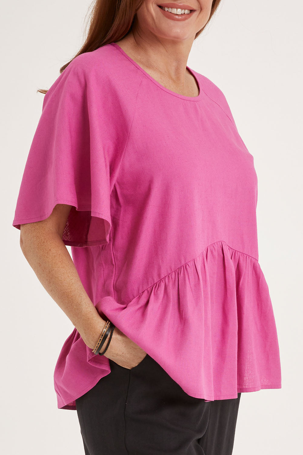 Model Sally wearing size 10 of the Cassandra Top in colour Azalea (Pink), from the front, cropped image