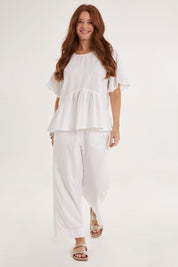 Model Sally wearing size 10 of the Cassandra Top in colour White (White), from the front, showing the whole outfit