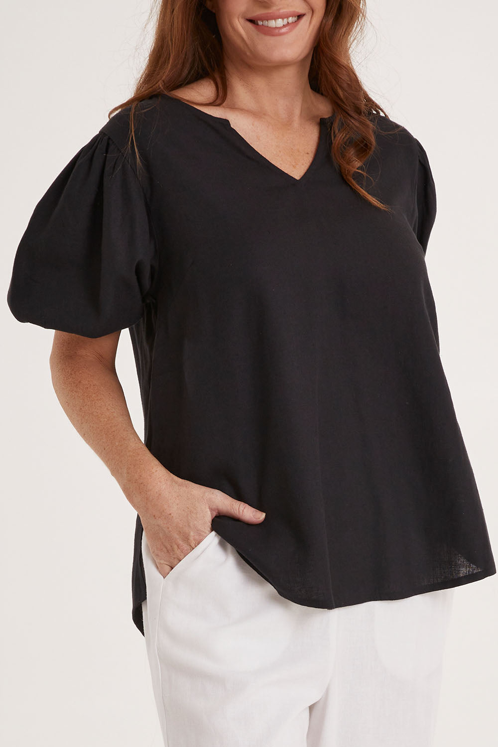 Model Sally wearing size 10 of the Alba Blouse in colour Coal (Black), from the front, cropped image