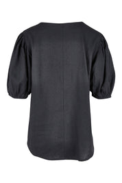 Product shot of the Alba Blouse in colour Coal (Black), from the back