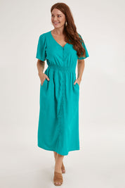 Model Sally wearing size 10 of the Whitney Dress in colour Teal (Green), from the front, showing the whole outfit