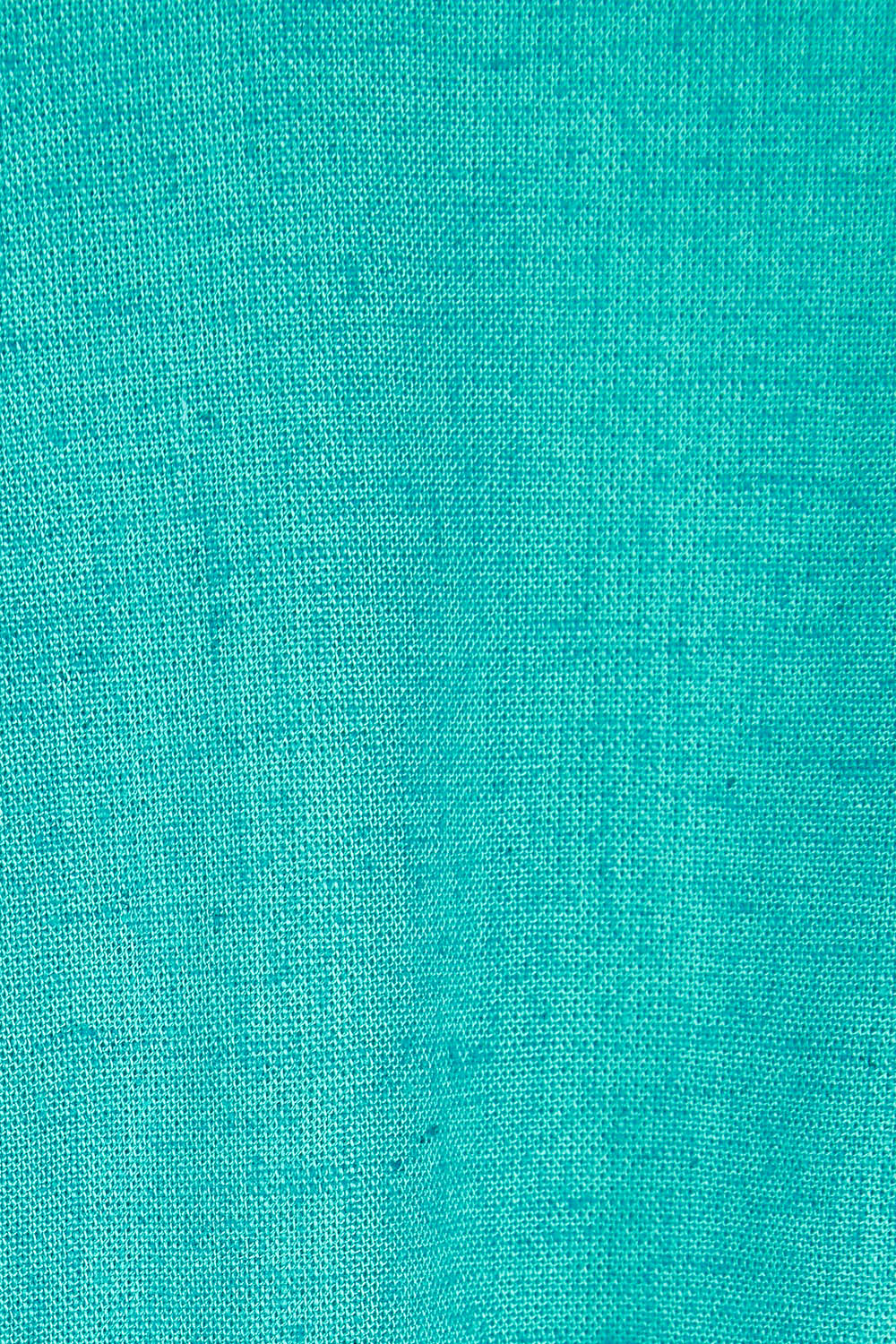 Product shot of the Whitney Dress in colour Teal (Green), detail