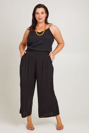 Model Poppy wearing size 16 of the Olympia Pant in colour Black (Black), from the front, showing the whole outfit