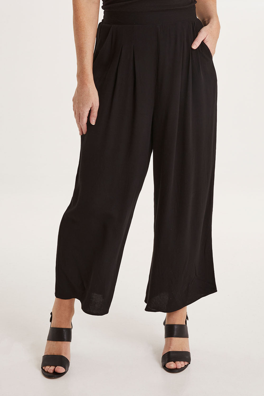 Model Sally wearing size 10 of the Olympia Pant in colour Black (Black), from the front, cropped image