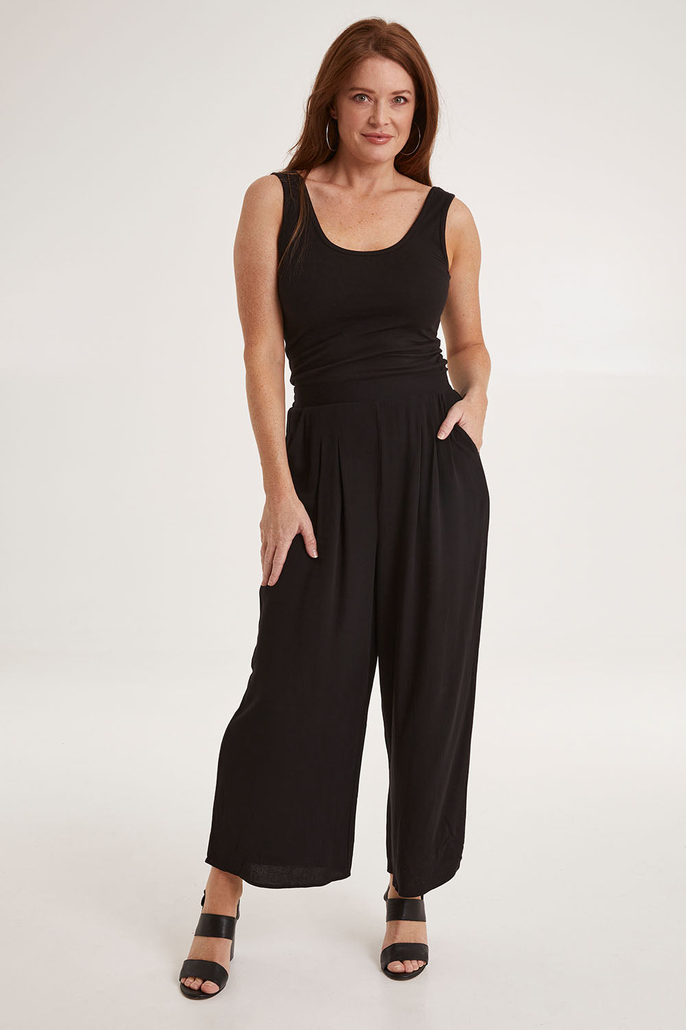 Model Sally wearing size 10 of the Olympia Pant in colour Black (Black), from the front, showing the whole outfit