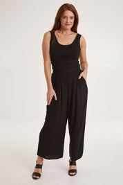 Model Sally wearing size 10 of the Olympia Pant in colour Black (Black), from the front, showing the whole outfit