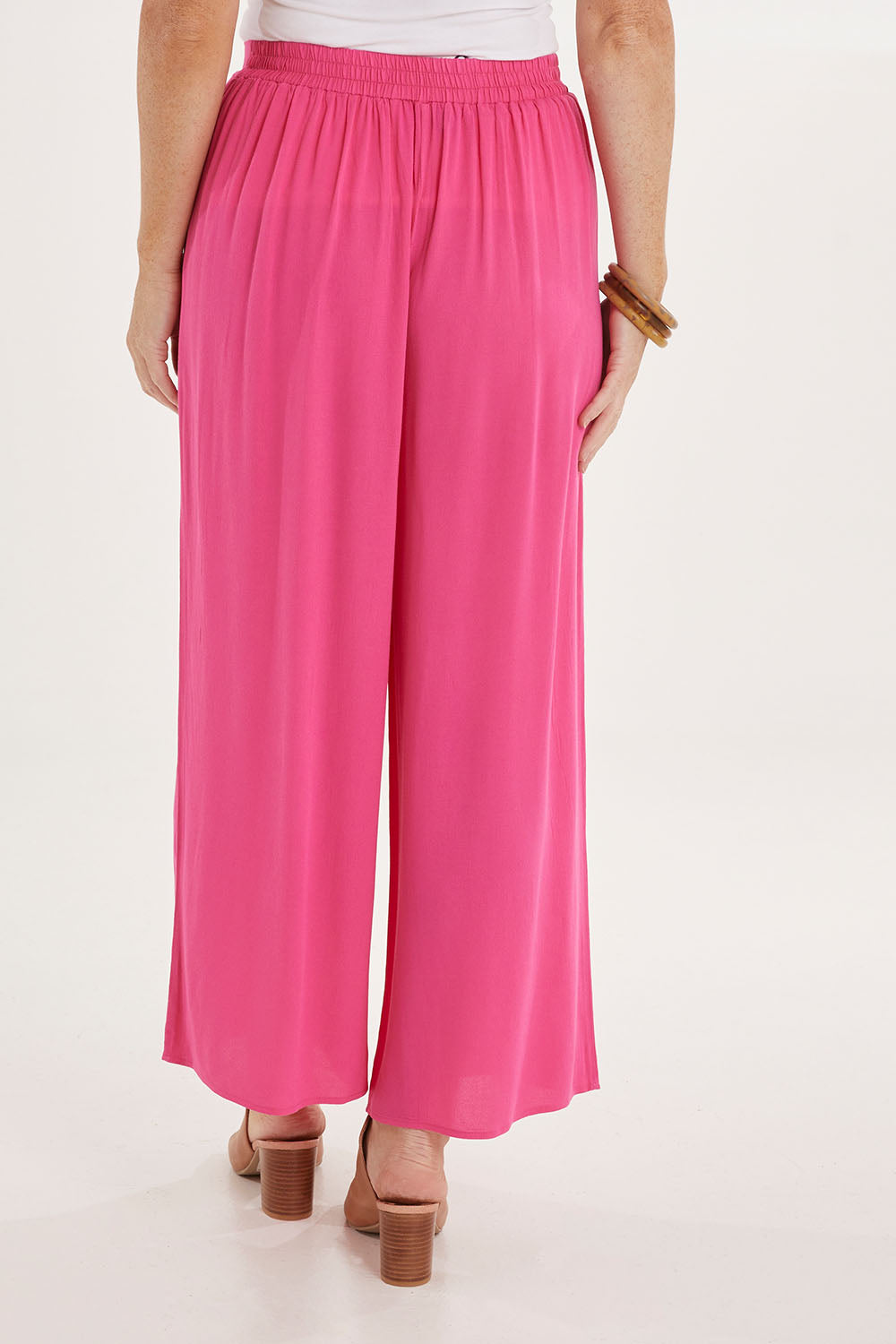 Model Sally wearing size 10 of the Olympia Pant in colour Frenchrose (Pink), from the back