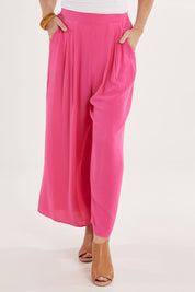 Model Sally wearing size 10 of the Olympia Pant in colour Frenchrose (Pink), from the front, cropped image