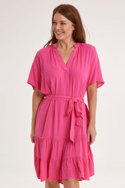Model Sally wearing size 10 of the Port Douglas Dress in colour Frenchrose (Pink), from the front, cropped image