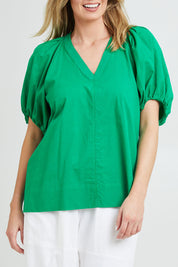 Model Grace wearing size 10 of the Juliet Blouse in colour Hollygreen (Green), from the front, cropped image