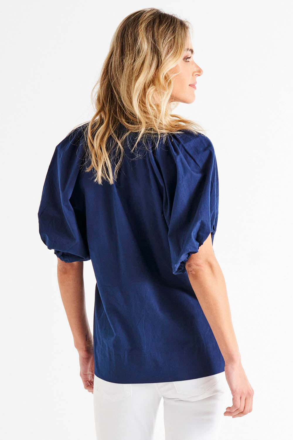 A model wearing the Juliet Blouse in colour Navy (Blue), from the back