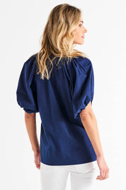 A model wearing the Juliet Blouse in colour Navy (Blue), from the back