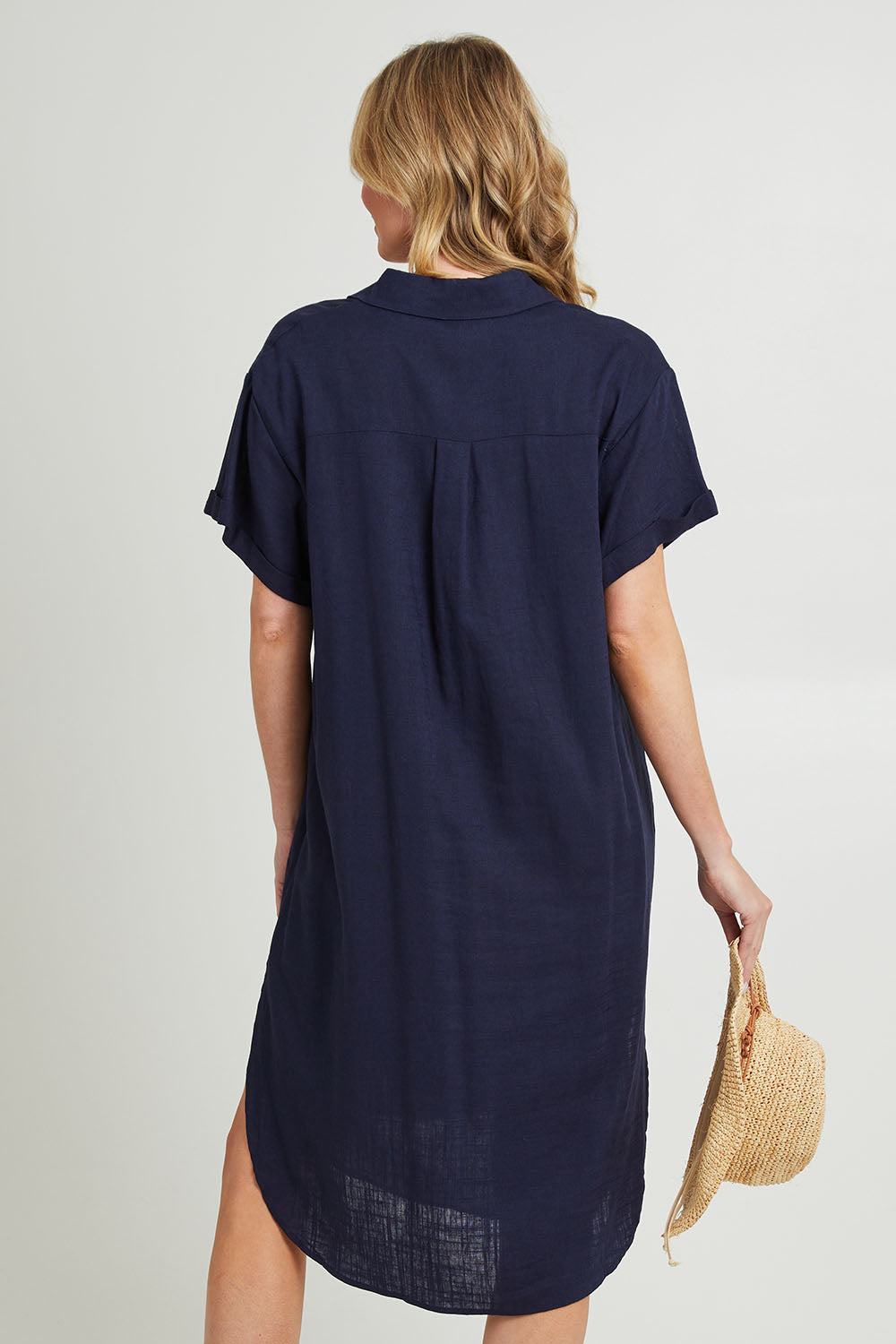 Model Grace wearing size 10 of the Lani Linen Shirt Dress in colour Navy (Blue), from the back