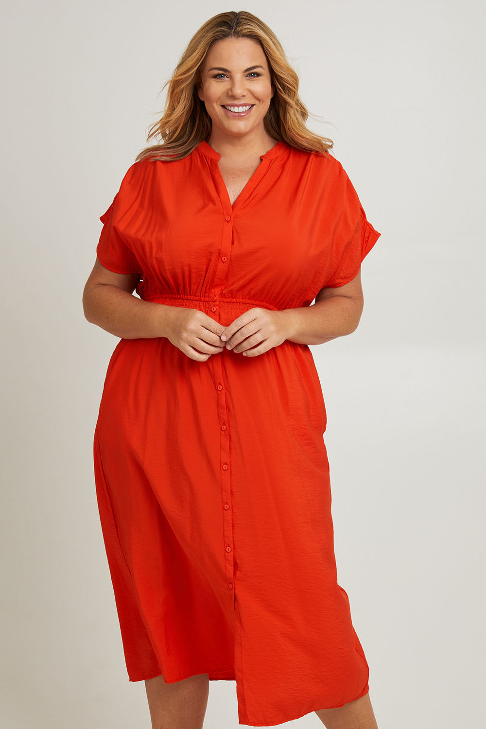 Model Fiona wearing size 16 of the Simone Dress in colour Cherry (Red), from the front, cropped image