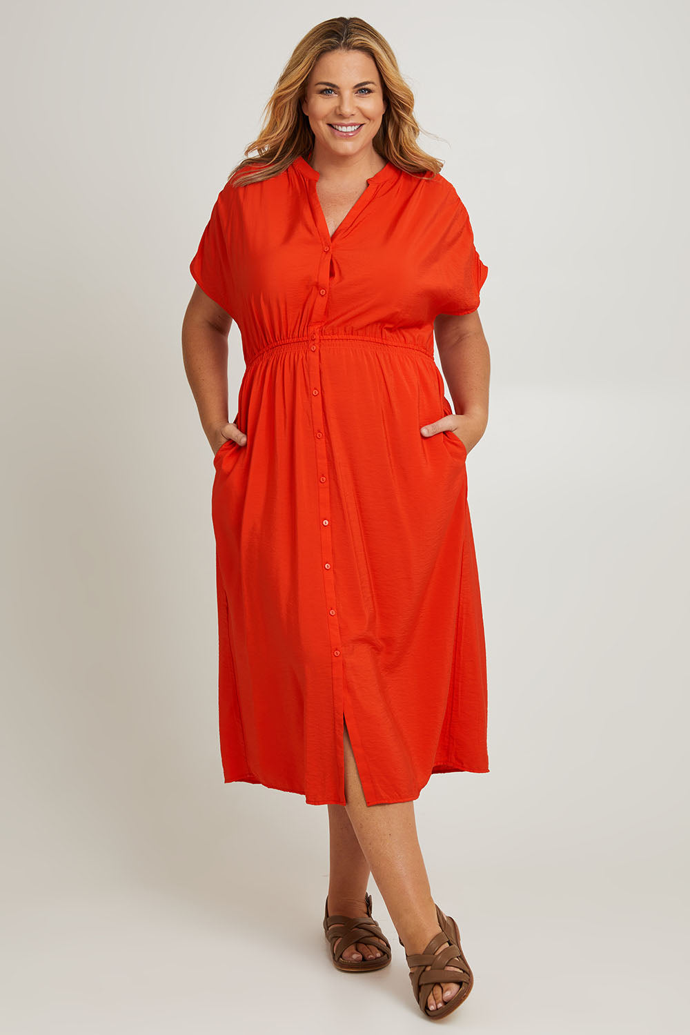 Model Fiona wearing size 16 of the Simone Dress in colour Cherry (Red), from the front, showing the whole outfit