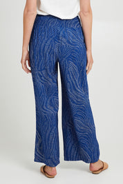 Model Madeline wearing size 10 of the Justine Pant in colour Blueprint (Blue), from the back