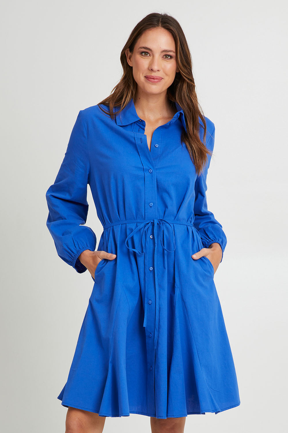 Model Madeline wearing size 10 of the Jada Dress in colour Irisblue (Blue), from the front, cropped image