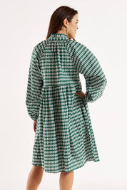 A model wearing the Cottage Dress in colour Diamond (Black), from the back