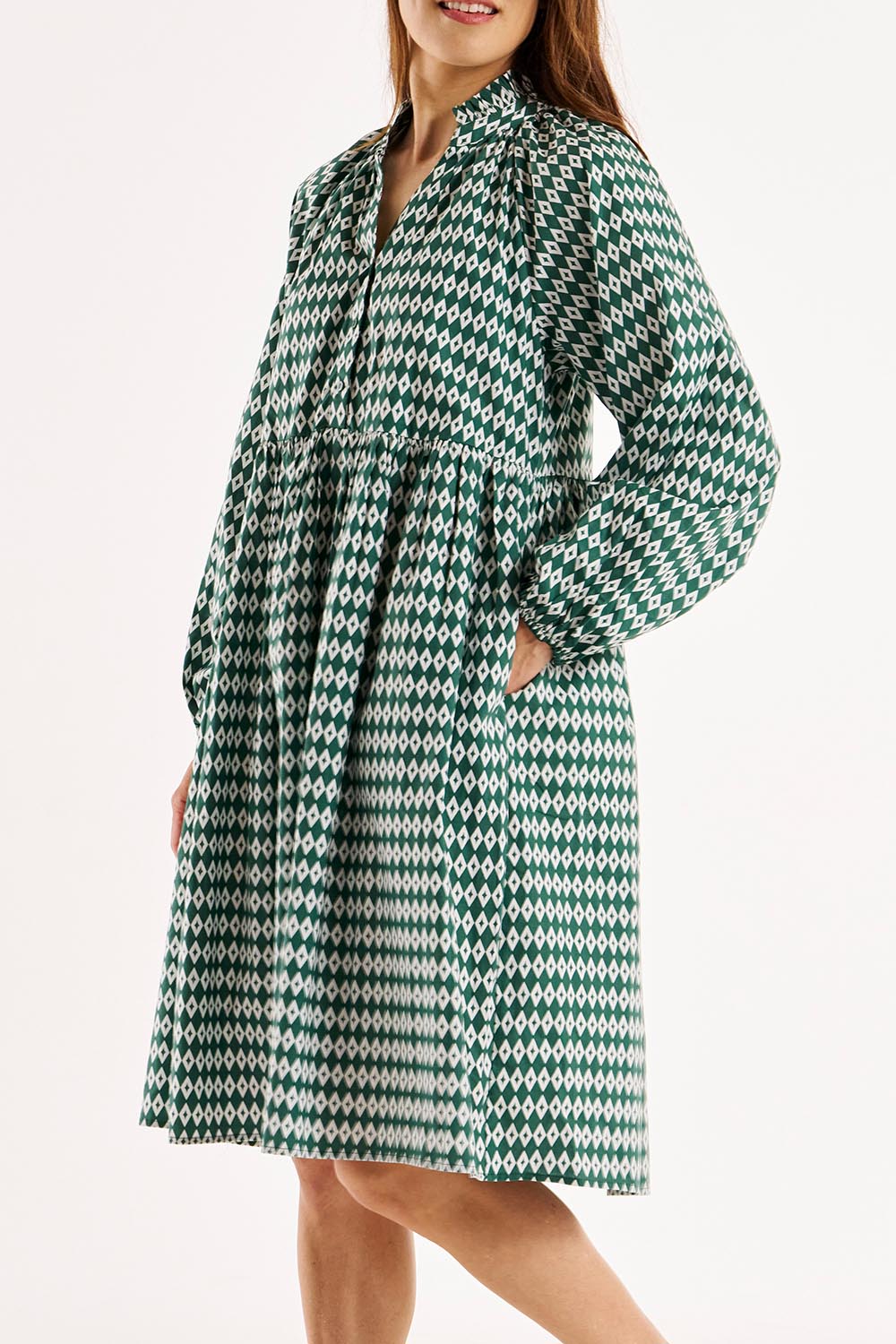 A model wearing the Cottage Dress in colour Diamond (Black), from the front, cropped image