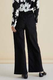 A model wearing the Wilma Wide Leg Jean in colour Black (Black), from the back